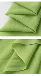Close-up of lightweight lime green wool scarf showing fine woven texture and soft drape