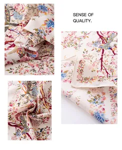 Macro view showing the elegant bird and floral patterns on a beige faux silk scarf detail