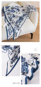 Close-up detail of soft blue and white floral print triangle scarf shawl