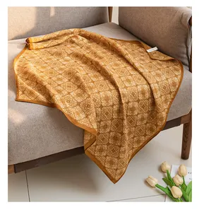 Detailed view of a 65cm vintage printed cotton linen square scarf draped on a sofa.