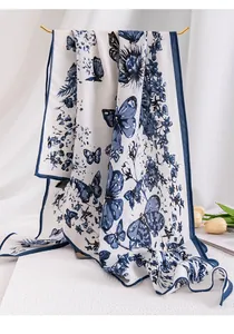 Detailed view of the blue butterfly and floral pattern on elegant white silk shawl wrap