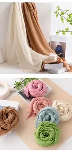Close-up view of soft solid-colored wool scarves in various vibrant spring colors