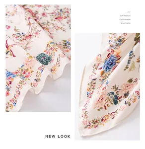 Macro view of beige faux silk scarf featuring vintage floral pattern and fine texture