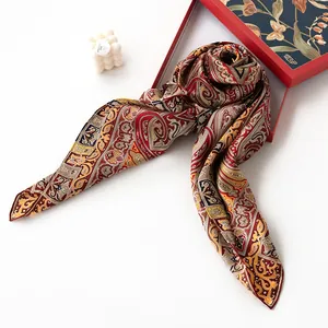 Luxurious mulberry silk scarf with paisley pattern, red and gold shawl in elegant gift box.