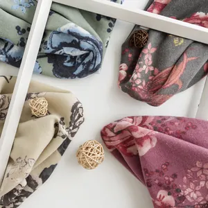 Macro detail of soft imitation cashmere scarves featuring elegant rose flower prints