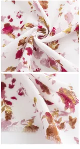 Detail van een zachte sjaal van imitatiekasjmier met elegante roze bloemenprint en franje.