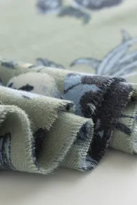Close-up of rose print faux cashmere scarf showing fabric texture and fringe