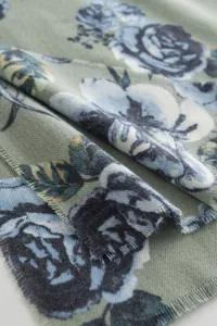 Detailed macro shot of vintage rose print on soft imitation cashmere scarf texture