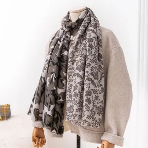 Detailed view of an elegant floral printed imitation cashmere scarf draped on a mannequin