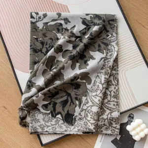 Detailed view of an elegant imitation cashmere scarf featuring floral botanical prints