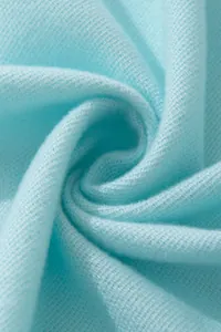Detailed macro view of light blue cashmere-like fabric showing soft texture and fine knit