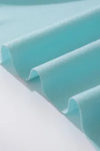 Close-up detail of light blue imitation cashmere scarf showing soft knit texture