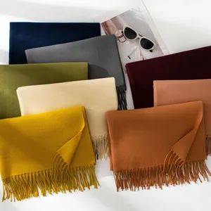 Selection of solid color faux cashmere scarves with tassels in various trendy colors