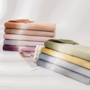 Collection of soft gradient colored cashmere-feel scarves stacked for elegant winter fashion