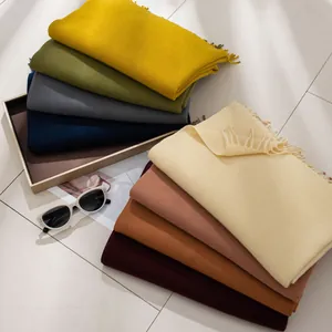 Selection of solid color faux cashmere scarves with tassels in various winter shades