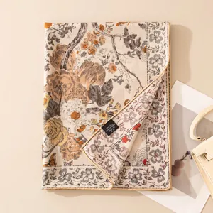 Detailed view of a vintage floral silk wool scarf showing the wash label and texture
