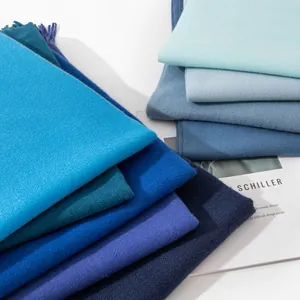 Elegant gradient stack of solid blue scarves made of soft imitation cashmere fabric