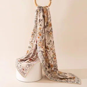 Close-up detail shot of an elegant exotic floral print silk wool scarf for women shawl