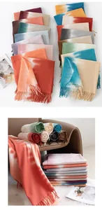 Detailed view of soft cashmere-feel scarves in various gradient colors and fringes.