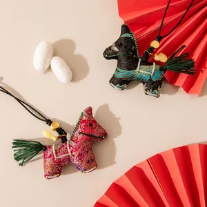 Traditional Chinese style Songjin silk horse pendants with green tassels and gold charms.