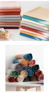 Detailed view of multicolored faux cashmere scarves in stacked and rolled arrangements