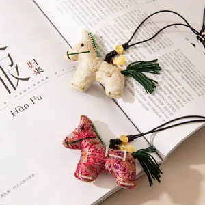 Intricate silk horse pendants with tassels on a Chinese culture magazine background