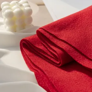 High-quality close-up showing the soft and dense texture of a vibrant red cashmere-like winter scarf