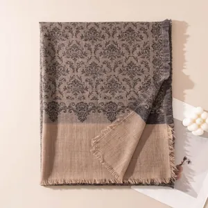 Detailed view of luxury cashmere shawl with elegant damask pattern and frayed edges