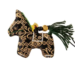 Handcrafted Song brocade horse charm with traditional silk patterns and green tassel detail.