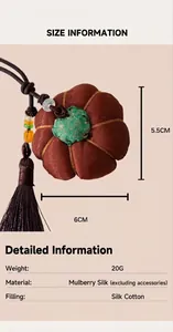 Macro shot of a handmade silk pumpkin pendant with measurements and material details.