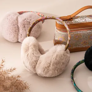 Detailed view of plush rabbit fur earmuffs with an elegant floral patterned headband