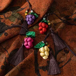 Detailed view of handmade silk grape pendants with tassels in traditional Chinese style
