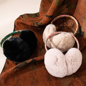 Soft plush winter earmuffs for women featuring vintage patterned headbands on fabric.