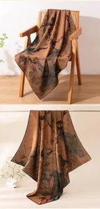 Elegant drape of traditional Xiangyun silk scarf showing intricate landscape patterns
