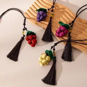 Detailed view of handcrafted silk grape pendants with elegant long tassels