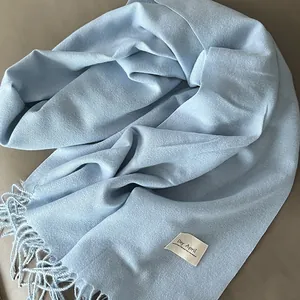 Soft light blue cashmere-like scarf with elegant fringe tassels for winter warmth
