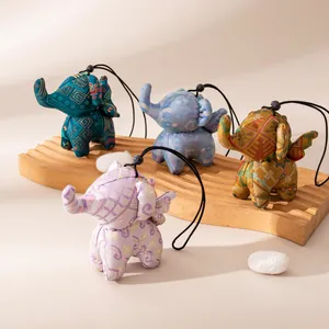 Handmade mulberry silk elephant bag charms with traditional patterns and gold finish