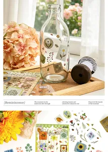 Detail of waterproof PET botanical stickers applied on a decorative glass bottle