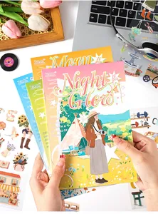 Close-up view of PET sticker books featuring day and night themed artistic illustrations