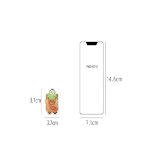 Size comparison of cute cartoon bear acrylic memo clip against an iPhone 12