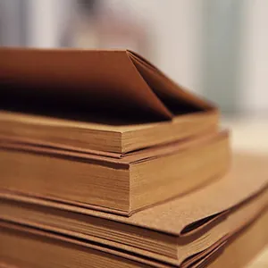 Detailed close-up showing the thick texture and vintage brown pages of kraft sketchbook