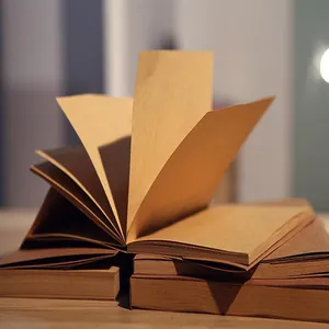 Macro view of vintage blank kraft paper sketchbooks showing thick textured pages