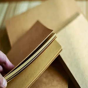 Close-up of retro kraft paper sketchbook showing the texture and thickness of blank pages