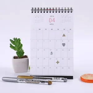 Metallic gold and silver paint markers for DIY cards and craftwork on desk calendar