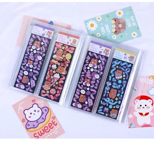 Detail view of transparent sticker storage album with colorful bear stickers inside