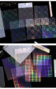 Detailed view of holographic PET sticker patterns with fireworks and grids for journaling.