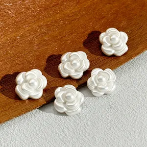 Close-up of white camellia flower buttons for elegant coats and sweaters
