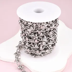 Detail view of silver punk rivet stainless steel chain on a spool for DIY jewelry