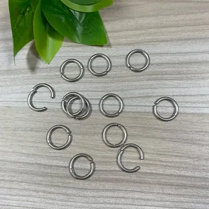 Detail view of various stainless steel non-pierced ear cuffs on wooden surface