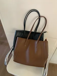 Large capacity minimalist tote bags in black and brown colors for daily commuting.